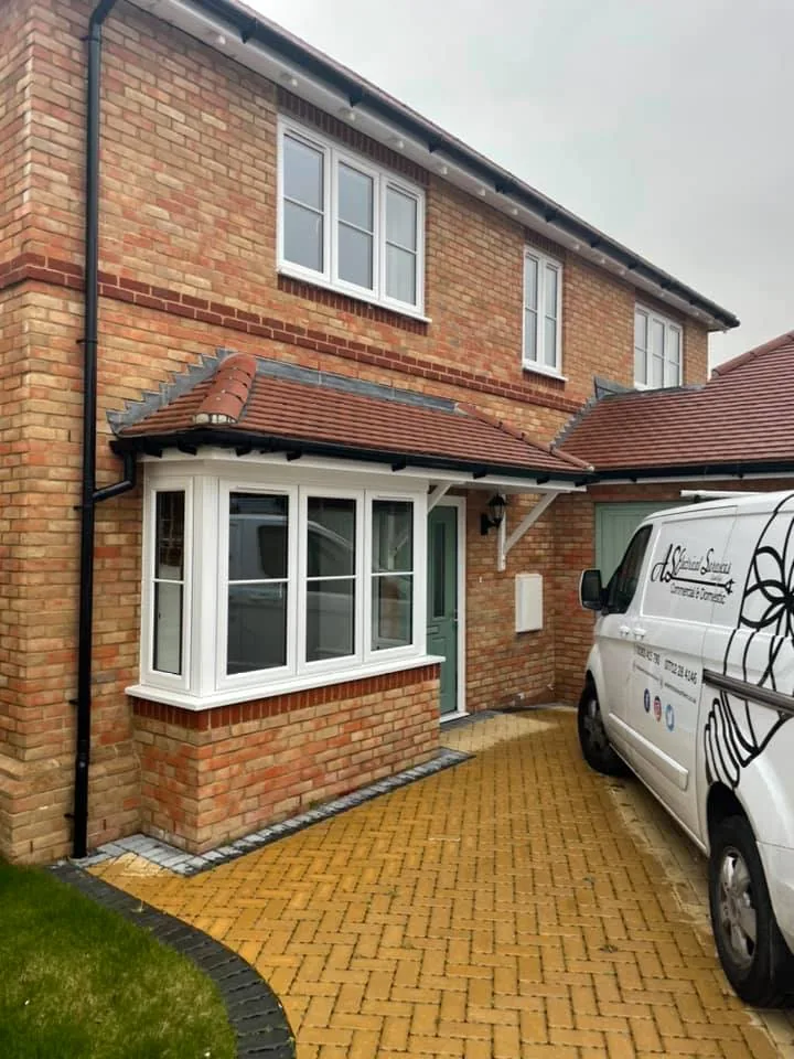 AS Electrical van outside a new-build home fitted with outdoor lighting