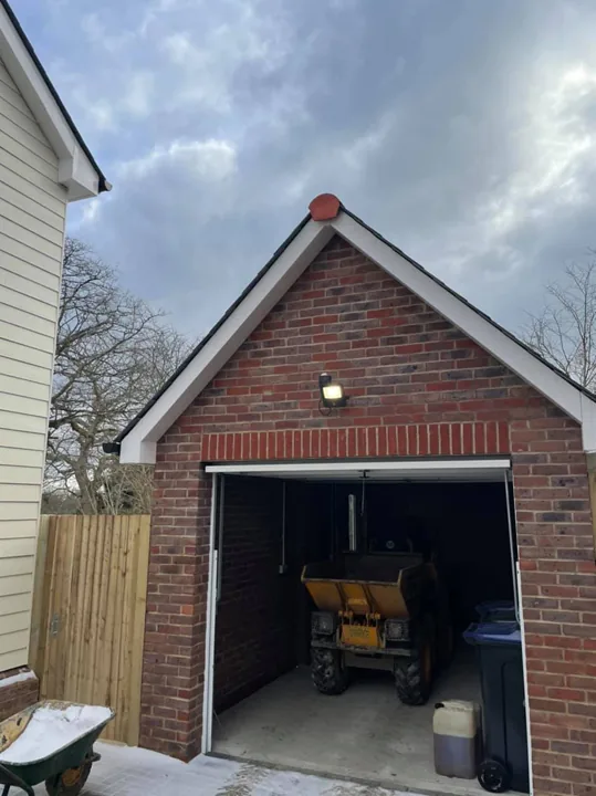 Exterior floodlight installed on a new-build brick garage