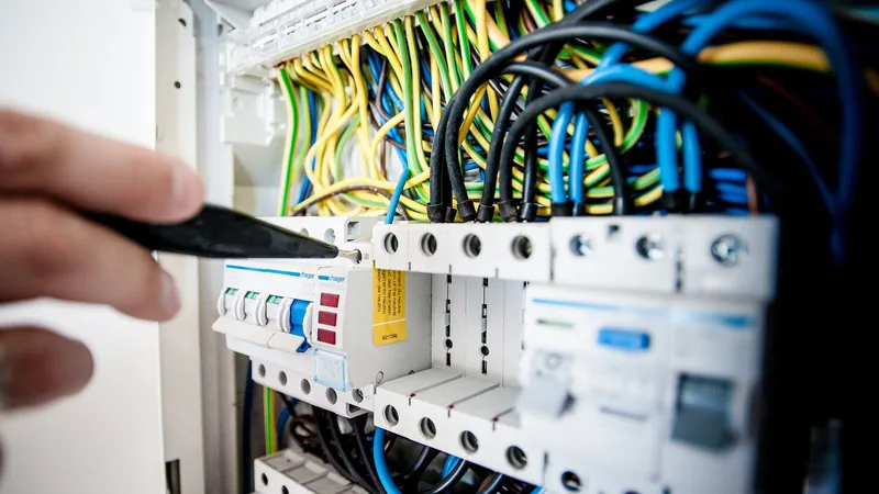 Electrician working on a domestic consumer unit and wiring