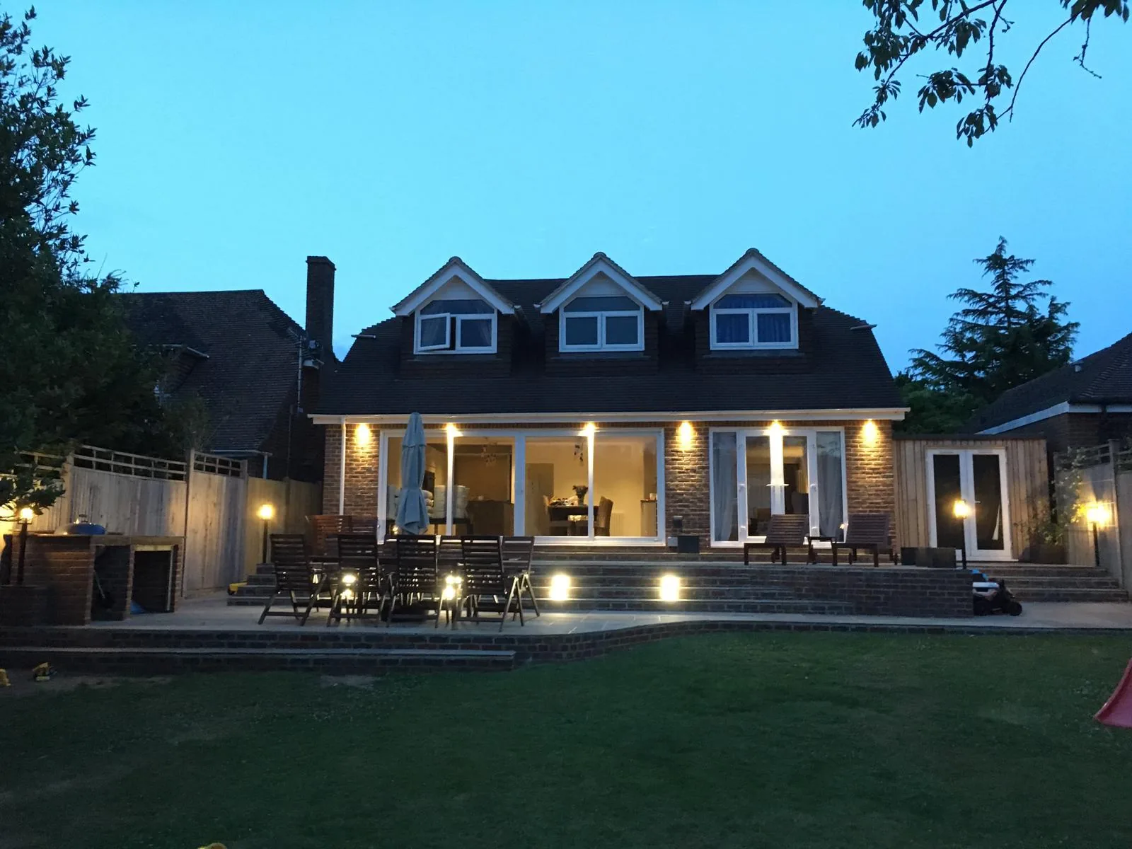 Exterior soffit and garden lighting installed on a Sussex home